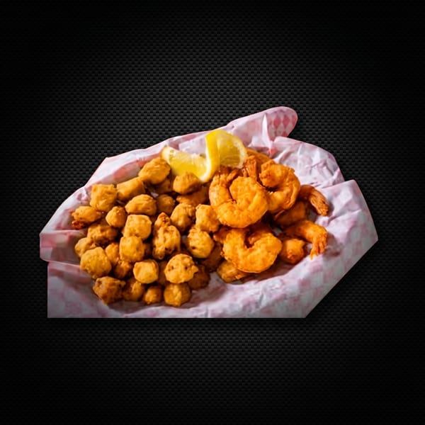 Fried shrimp and hush puppies with a lemon wedge, served in a paper-lined basket.